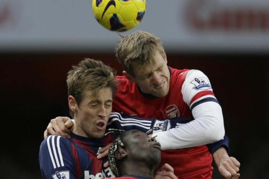 Stoke's Peter Crouch is beaten in an aerial challenge. Photo: AP