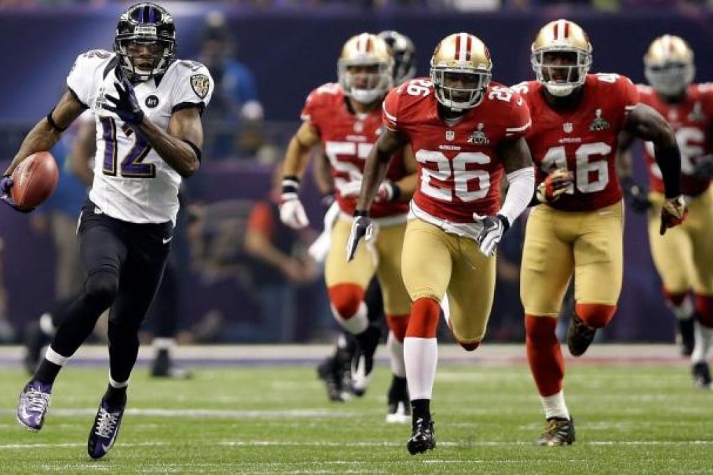 The Ravens' Jacoby Jones on his way to a touchdown in the third quarter of the Super Bowl. The sport's biggest game was marred by a 34-minute power outage. Photo: AFP