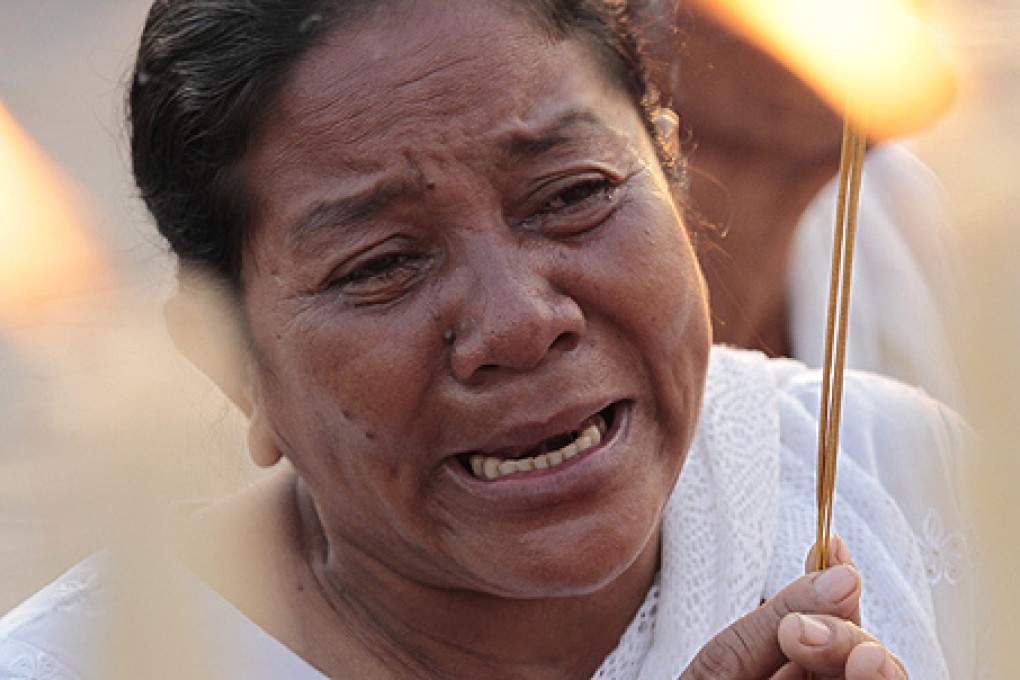 A Cambodian mourner cries as she prays for the former king. Photo: EPA