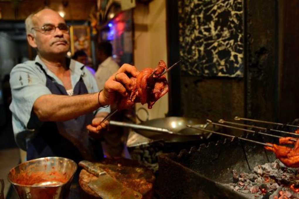 A chef prepares to grill a chicken at a Mumbai restaurant. India’s growing wealth has increased demand for meat, particularly from the newly affluent middle class. Photo: AFP