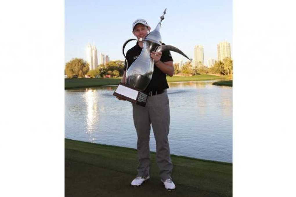 Stephen Gallacher shows off his Dubai trophy. Photo: EPA