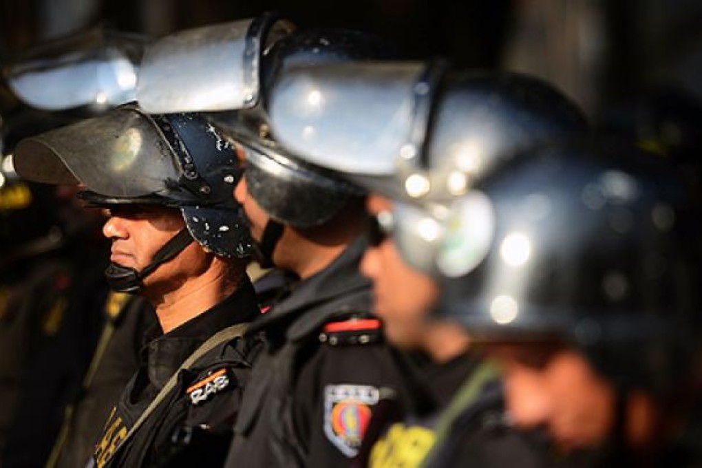 Rapid Action Battalion personnel keep watch outside the International Crimes Tribunal court during a nationwide strike in Dhaka on Tuesday. Photo: AFP