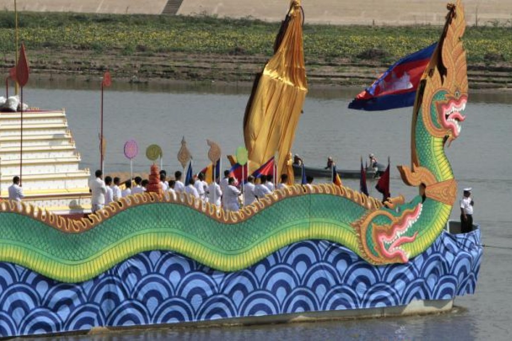 A royal barge carries the ashes on the Mekong. Photo: AP