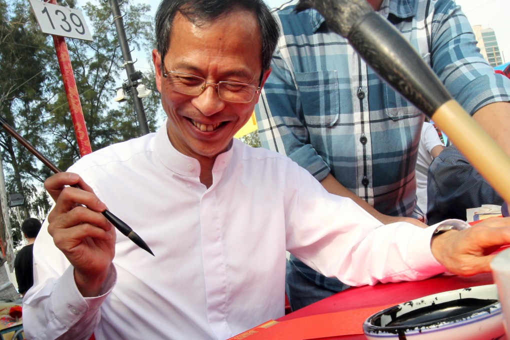 Legislative Council president Jasper Tsang Yok-sing writing spring couplets for visitors at Victoria Park yesterday. Photo: David Wong