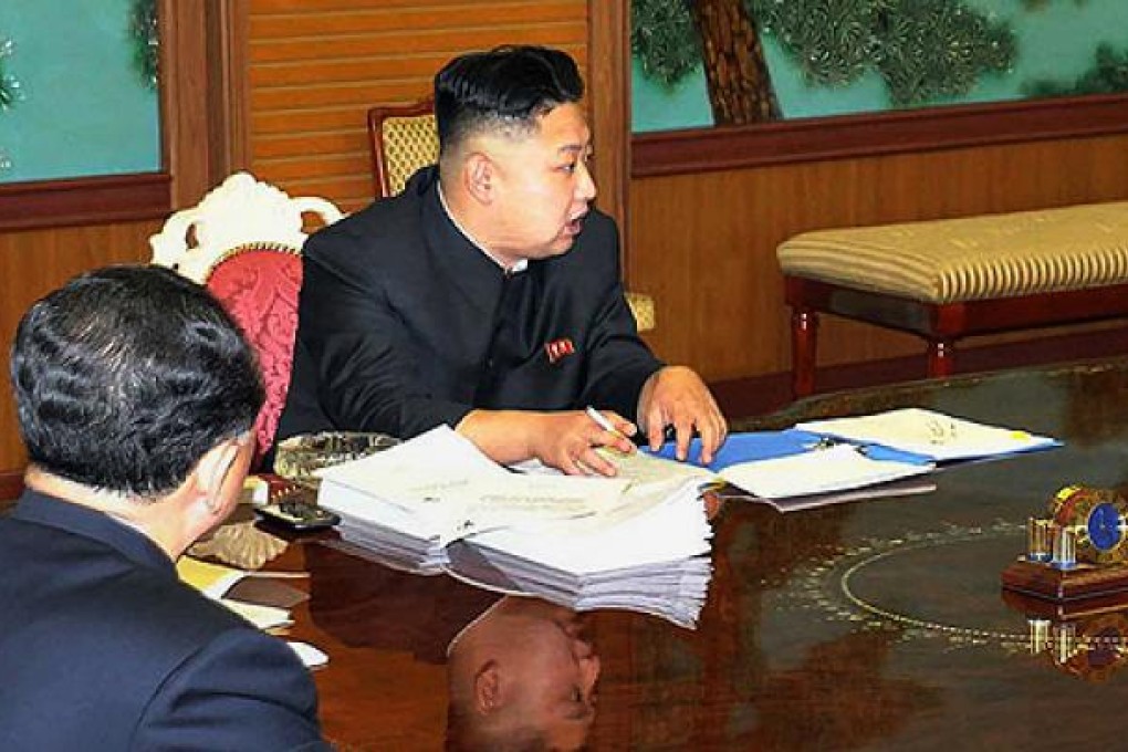A smartphone is shown next to Kim Jong-un as he presided over a meeting with top national security advisers last week. Photo: AFP