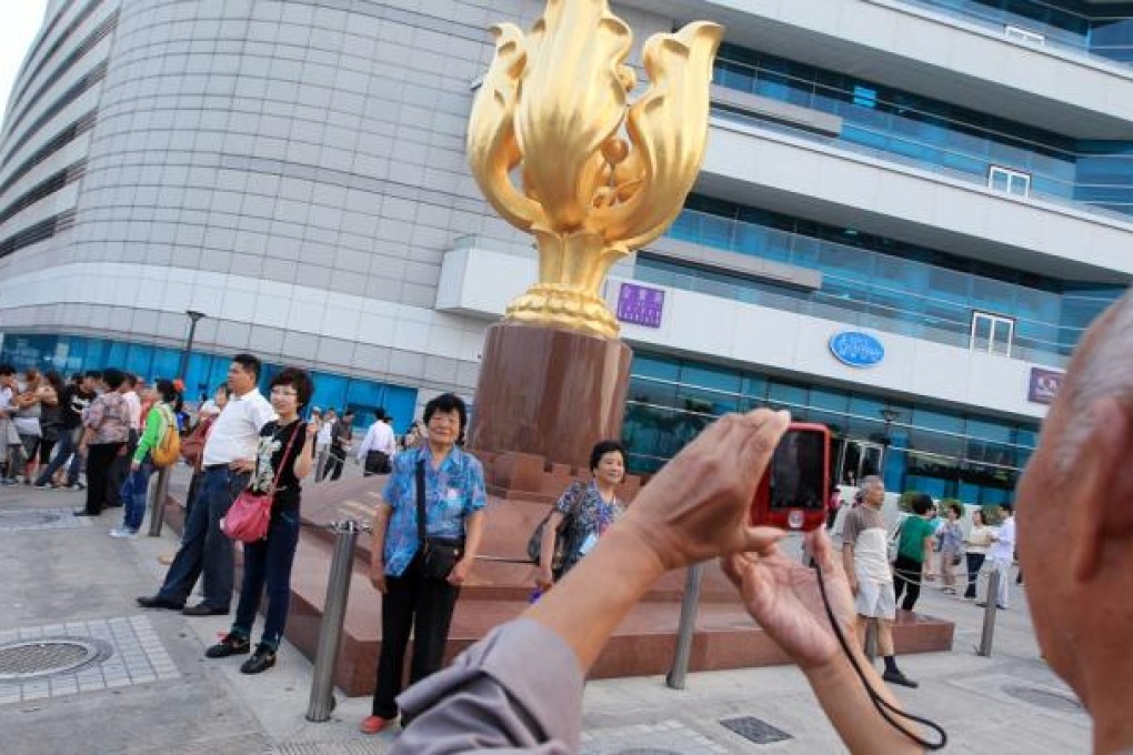Mainland tourists visit Golden Bauhinia Square in Wan Chai. Photo: Jonathan Wong