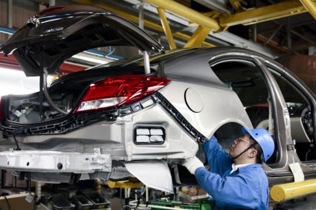 A General Motors car being assembled at a plant in Shanghai. GM is targeting sales of five million vehicles by 2015. Photo: Bloomberg