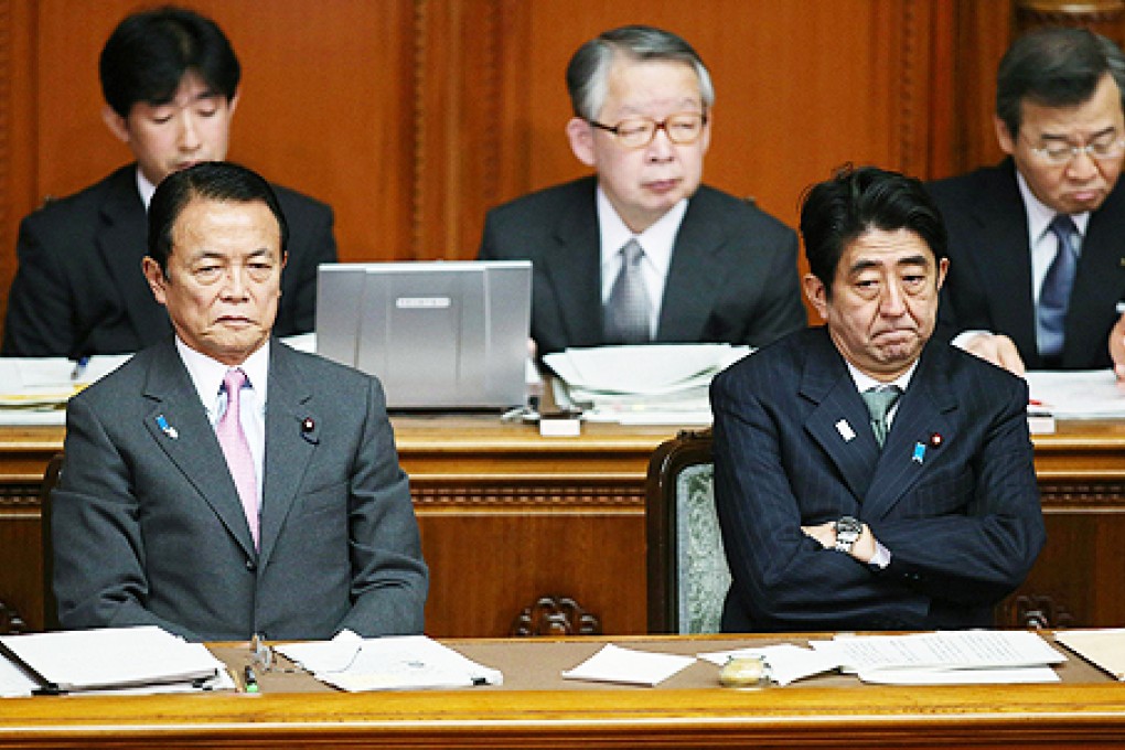 Japanese Prime Minister Shinzo Abe (right) answers questions in parliament on Wednesday. Photos: AFP