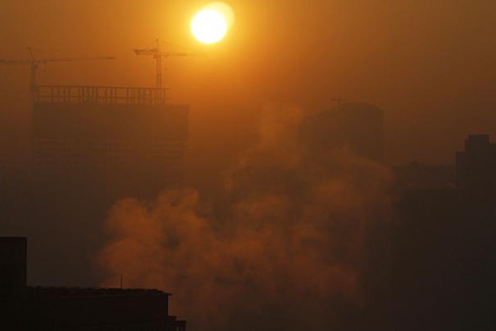 The sun rises over a hazy Beijing. Recent pollution in the capital was blamed on emissions from coal-burning power stations and exhaust fumes from vehicles. Photo: Reuters