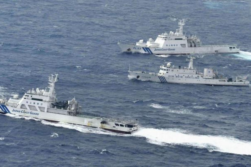 A Chinese marine surveillance ship Haijian No. 66 (centre) cruises next to Japan Coast Guard patrol ships in the East China Sea. Photo: Reuters
