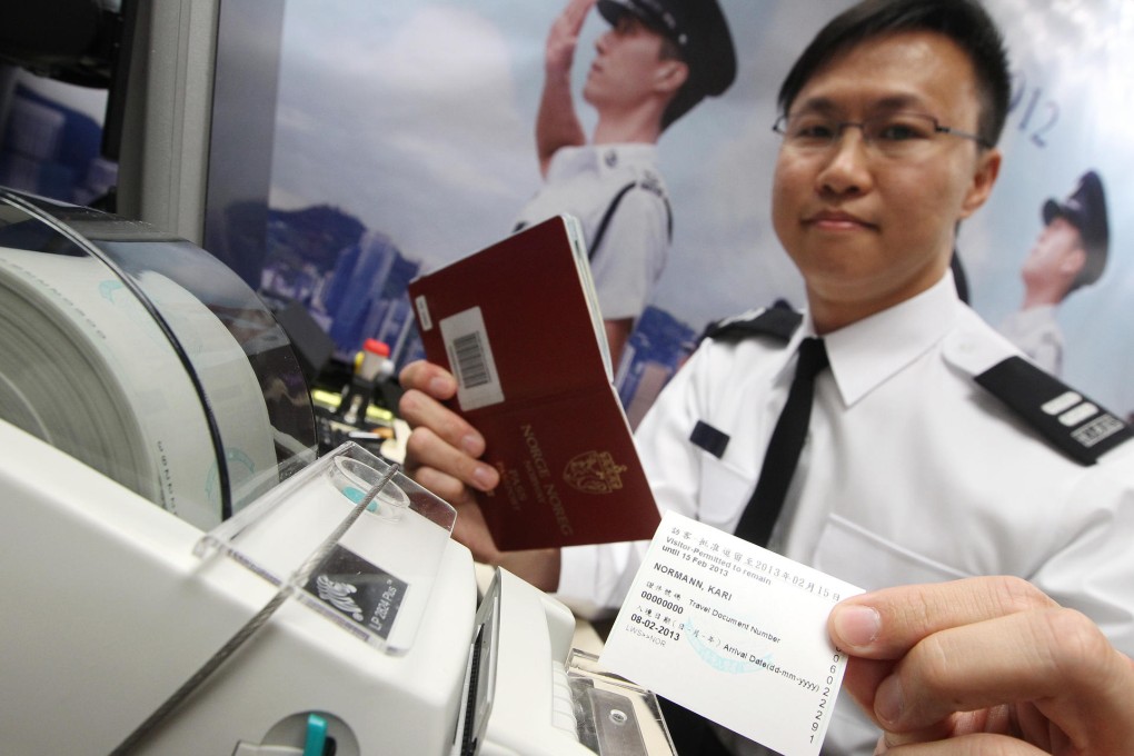 Senior immigration assistant So Ka-shun tests the non-stamping clearance service that comes into effect next month. Photo: Sam Tsang