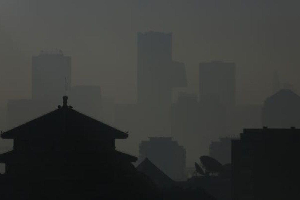 The silhouettes of buildings are seen through haze in Beijing. Photo: Reuters