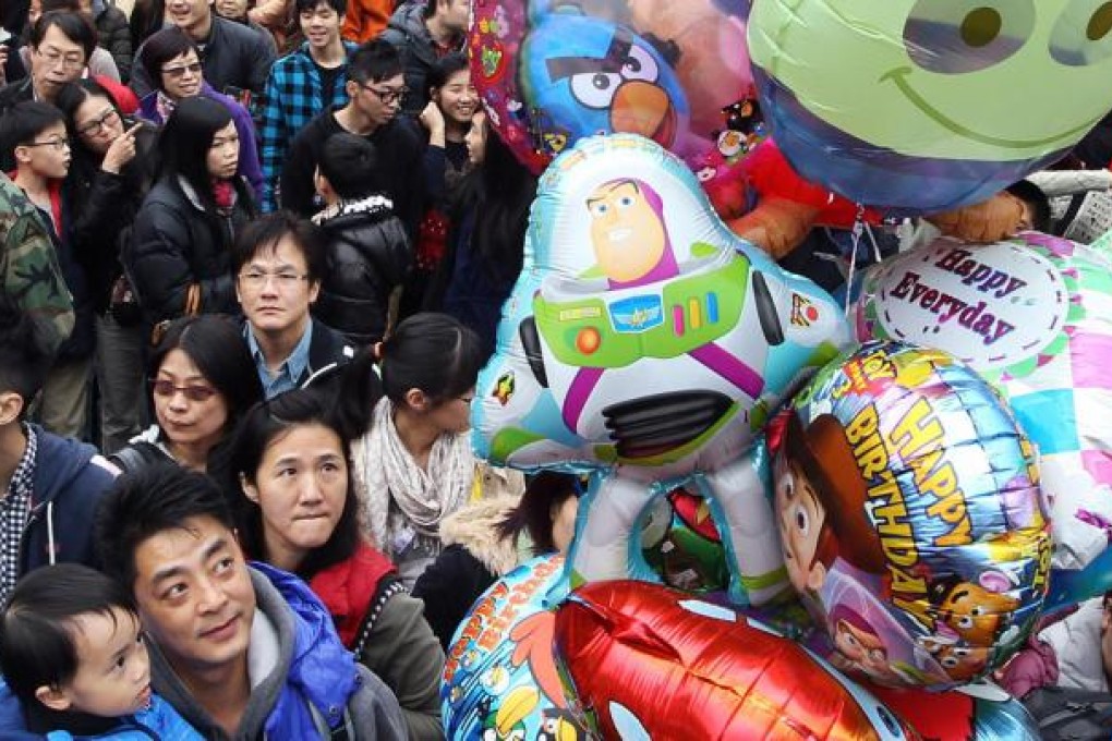 Visitors indulge the festive colour at Victoria Park's Lunar New Year fair. Photo: Sam Tsang
