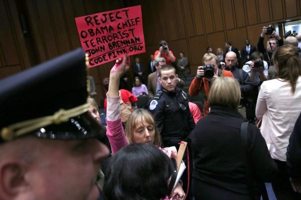 Anti-war protesters disrupt the start of a nomination hearing for U.S. Assistant to the President for Homeland Security and Counter terrorism John Brennan before the Senate Intelligence Committee. Photo: AFP
