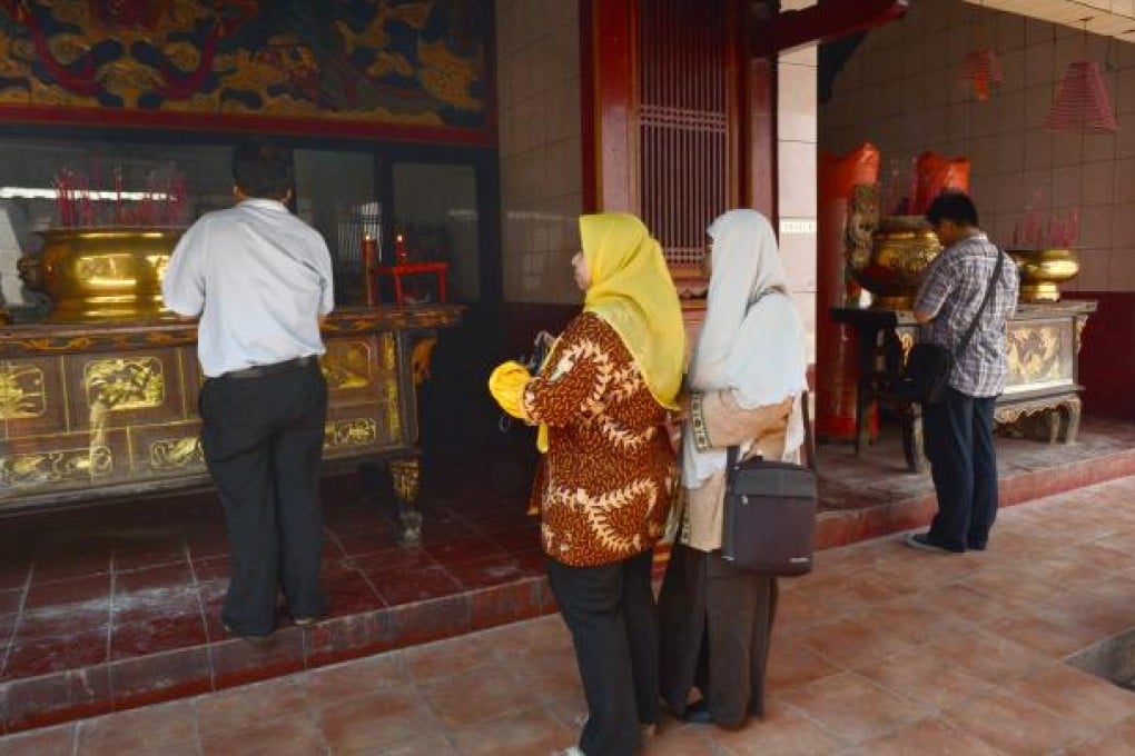 Two Muslim women visit a Buddhist temple in Jakarta. Photo: AFP