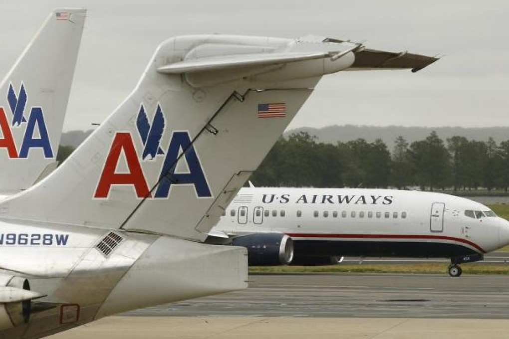 A US Airways plane passes American Airlines planes at Ronald Reagan National Airport in Washington. Photo: Reuters
