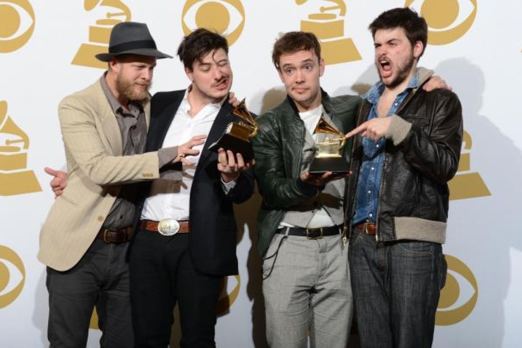 British folk rockers Mumford & Sons clown around with their unexpected trophies at the Staples Centre in Los Angeles. Photo: AFP