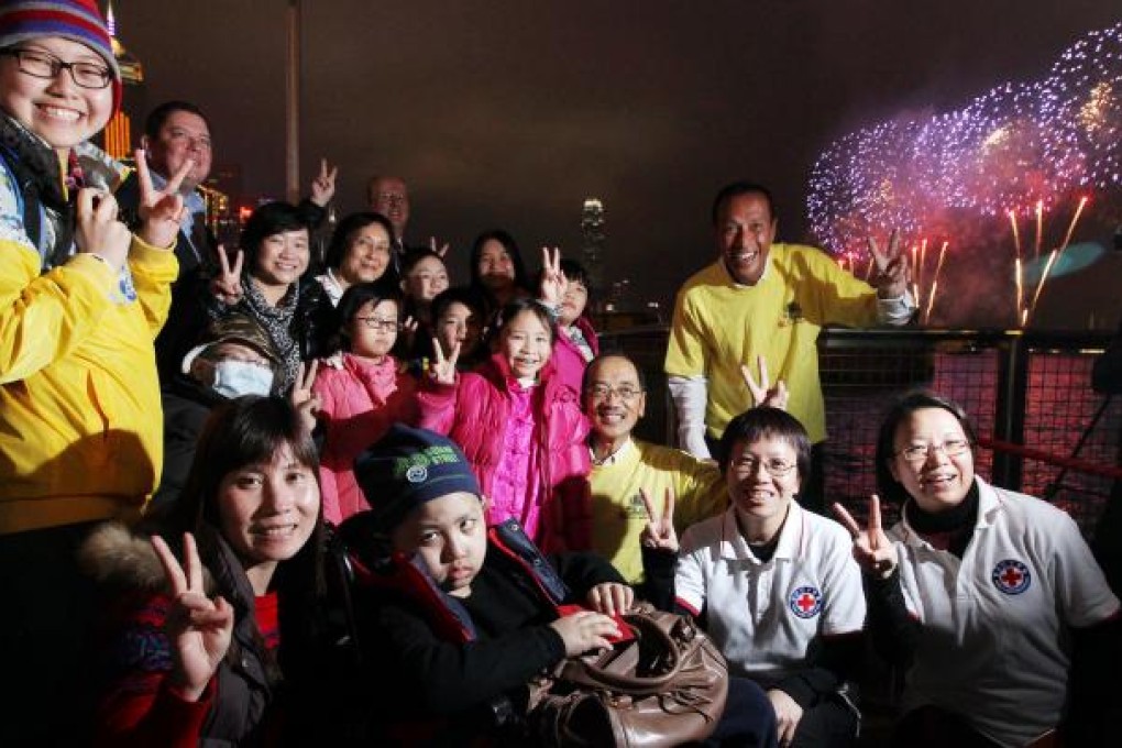 Young cancer patients get a front-row seat at the yacht club in Causeway Bay for the Lunar New Year fireworks. Photo: Felix Wong
