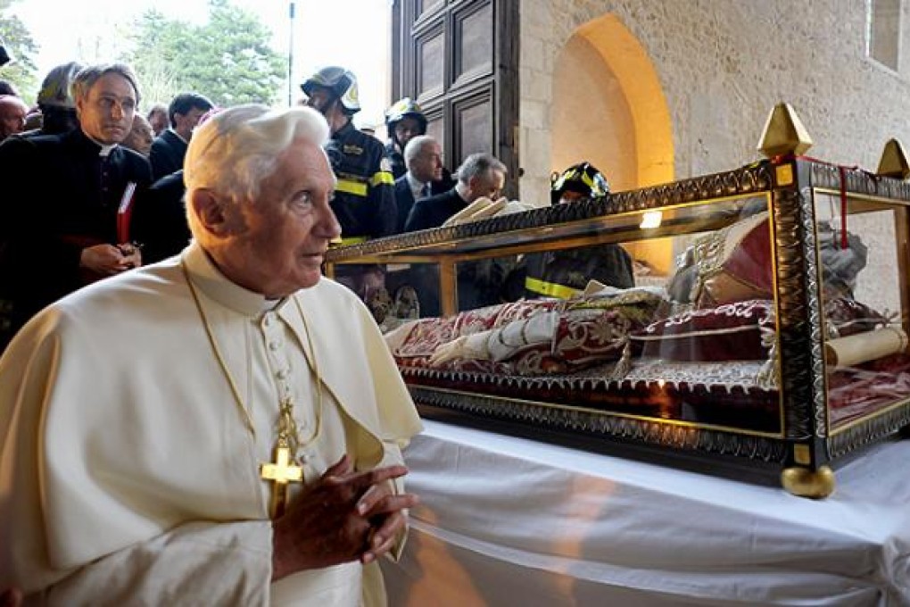 Pope Benedict XVI stands beside the relic of Pope Celestine V in the church St Maria of Collemaggio after the earthquake in L'Aquila in 2009. Photo: Reuters