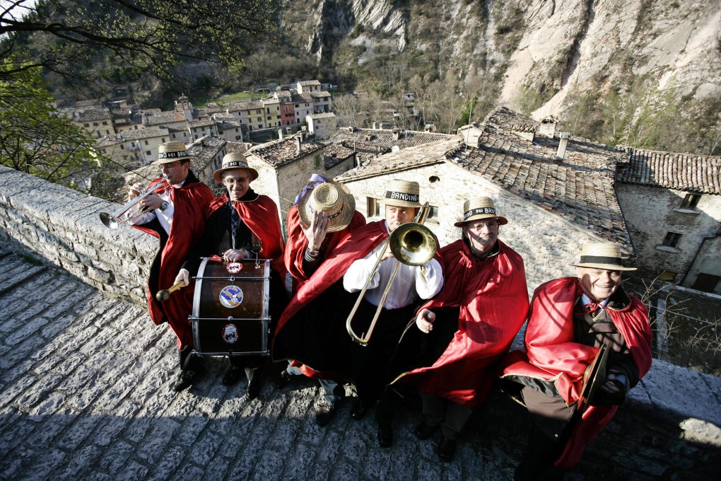 Members of the "ugly person's band" strike a chord in Piobbico, Italy. Photos: Reuters