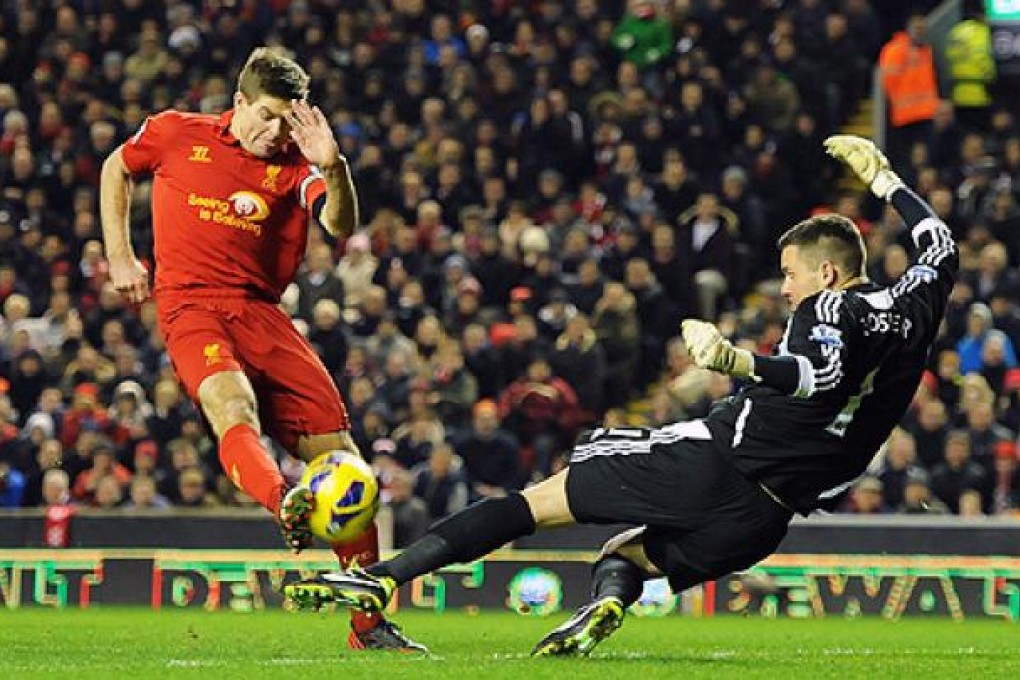 Liverpool's Steven Gerrard (left) has a shot saved from West Bromwich Albion's keeper Ben Foster. Photo: EPA