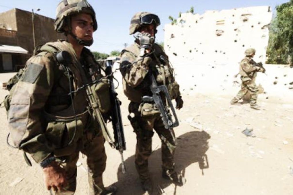 French soldiers holding F1 assault rifles patrol in Gao, Mali. Photo: AFP