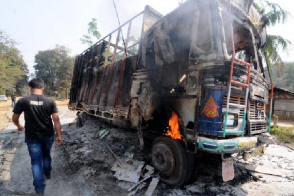 The wreckage of a truck following violence in Goalpara, some 135km from Guwahati. At least 11 people have been killed in clashes between police and tribal groups there. Photo: AFP