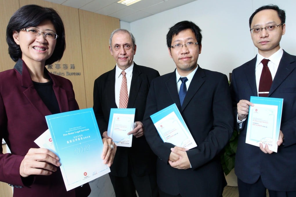 Melissa Kaye Pang, Jal Karbhari, Chow Chun-man and Bowie Yip are honoured for their volunteer work. Photo: May Tse