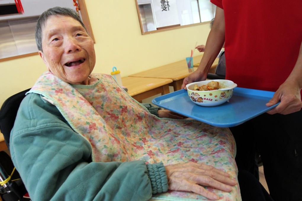 Lending a hand: an 86-year-old woman is served lunch at the Haven of Hope Holistic Care Centre, in Tseung Kwan O. Photo: David Wong