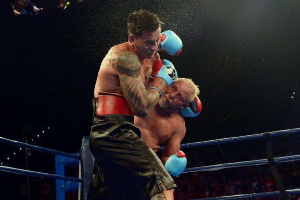 Sonny Bill Williams takes a blow from Francois Botha in their fight last week. Photo: EPA