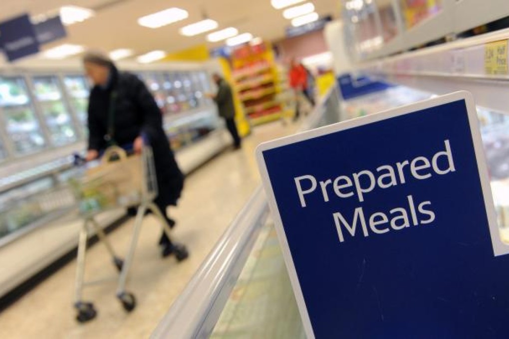 A customer walks through the frozen prepared meals section at a Tesco store in London. Some Tesco Everyday Value Spaghetti Bolognese was found to contain 60 per cent horsemeat, after DNA tess were carried out. Photo: EPA