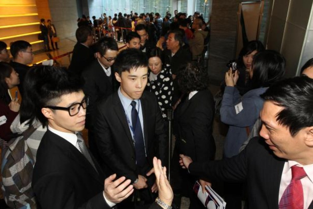 Sun Hung Kai Properties agents get down to serious business at the launch of Residence 88 in Yuen Long. Photo: Edward Wong