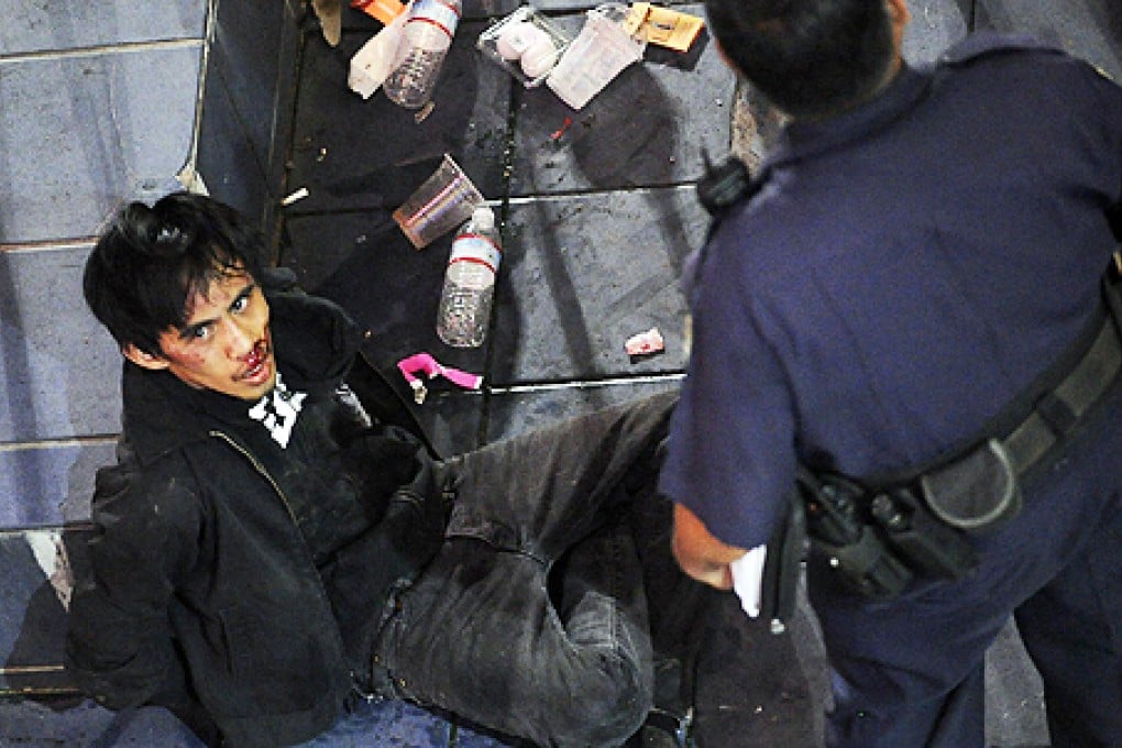 Police handcuff Chad Ryan Desoto, 21, of Tamuning, Guam, after several people were injured in a stabbing spree. Photo: AP