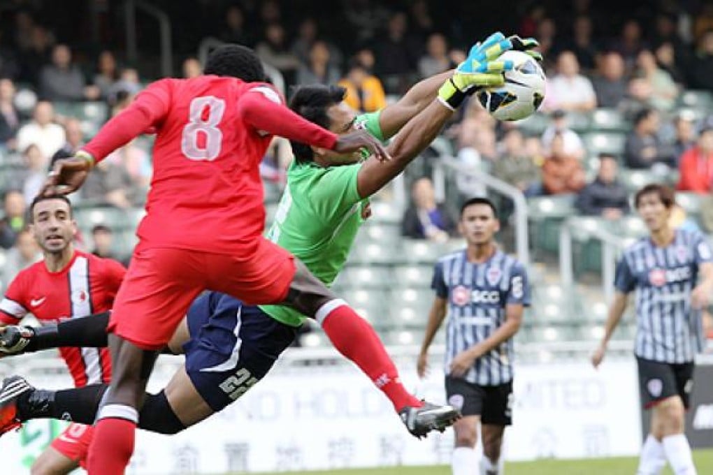 Muangthong United goalkeeper fends off a shot from one of  the Hong Kong League XI during their play-off at Hong Kong Stadium in  Causeway Bay  on Wednesday. Photo: Edward Wong