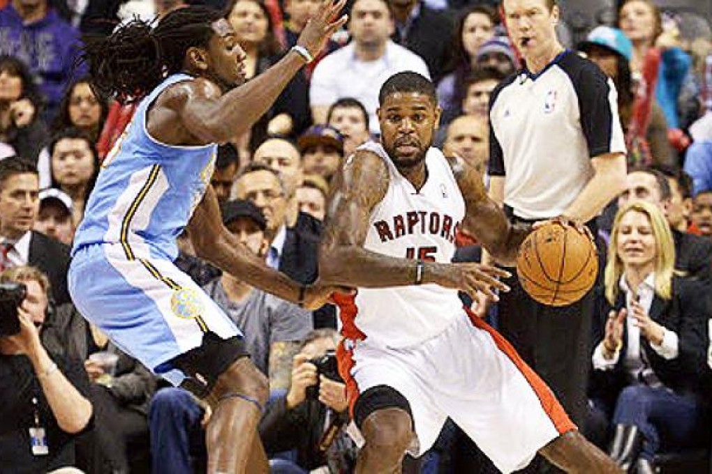 Toronto Raptors Amir Johnson (R) moves around Denver Nuggets Kenneth Faried during the second half of their NBA basketball game in Toronto. Photo: Reuters