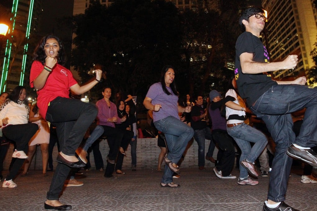 People do the Break the Chain dance at Chater Garden, Central.