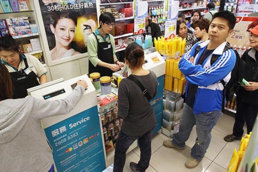 People queue up for milk powder at a branch of Watson in Choi Yuen Estate, Sheung Shui. Photo: Edward Wong
