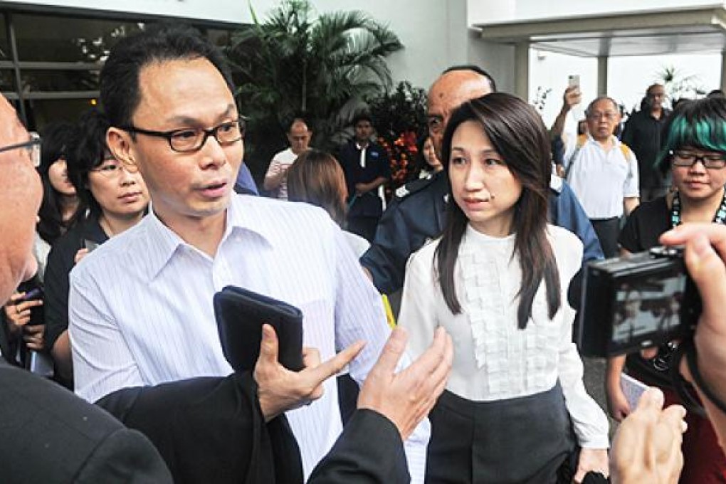 Former director of the Central Narcotics Bureau, Ng Boon Gay (centre left) and his wife leave the Subordinate court in Singapore on Thursday. Photo: AFP