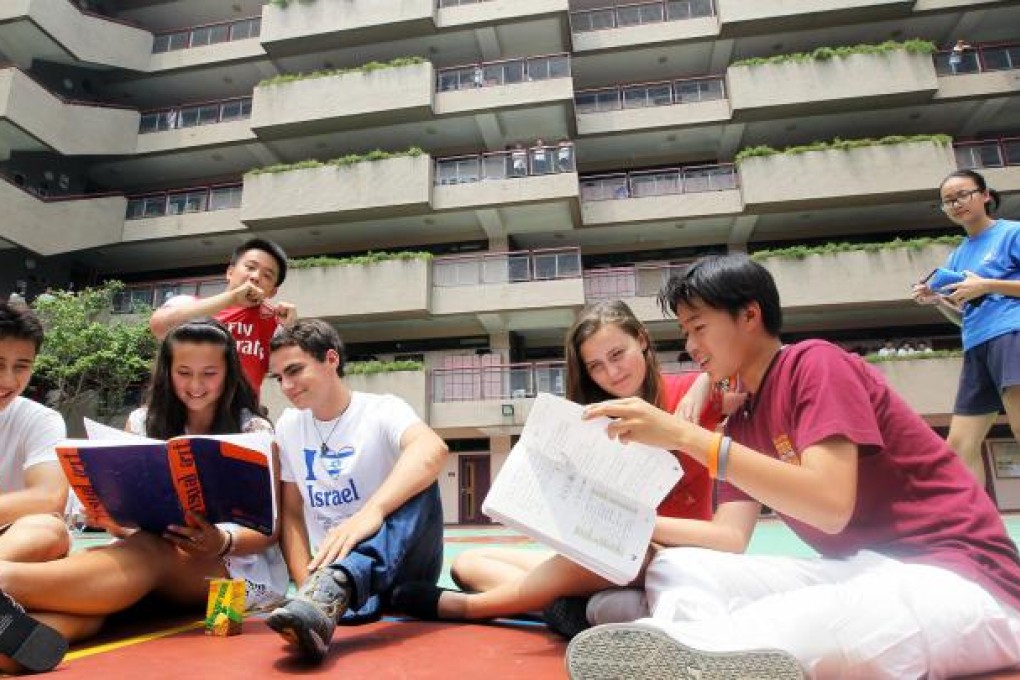 Chinese International School students Cameron Zeluck, Saskia Leung, Aaron Zweig, Phoebe Wilson and Riley Tseng chat during break time. The school is planning to transfer its Year 10 students to its new campus in Hangzhou. Photo: Edward Wong