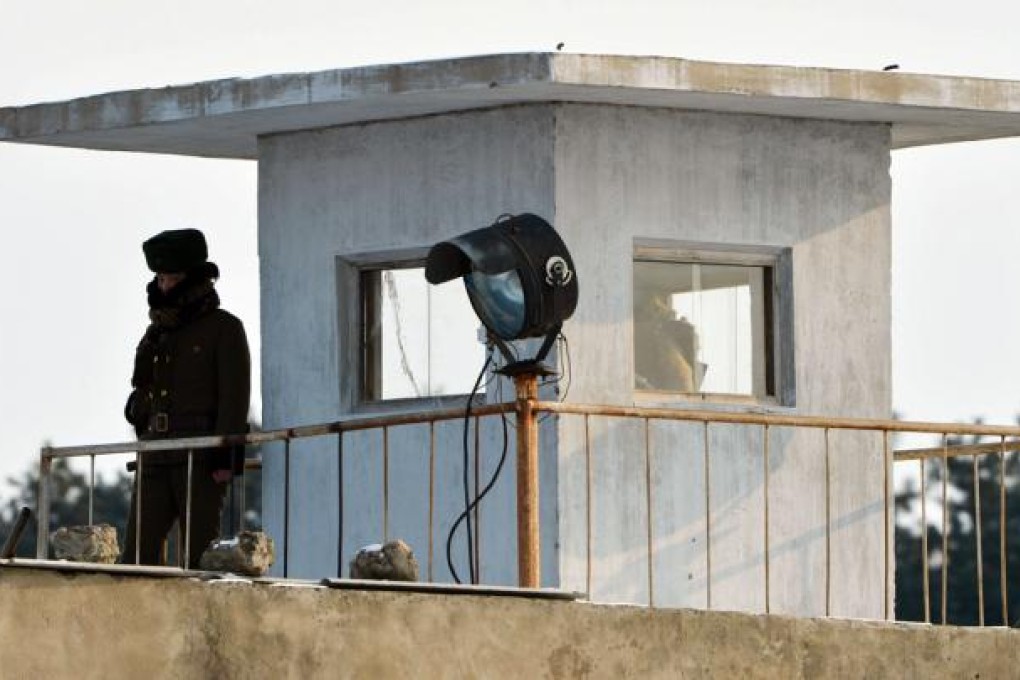 A North Korean soldier stands guard beside the Yalu River near the North Korean town of Sinuiju after the country conducted its third nuclear test across from the Chinese city of Dandong. Photo: AFP