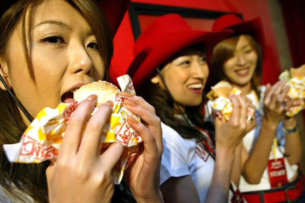 Models taste McDonald's Japan's latest product in Tokyo. Photo: AP