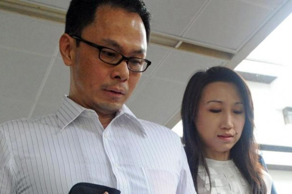 Ng Boon Gay and his wife leave court on Thursday. Photo: AFP