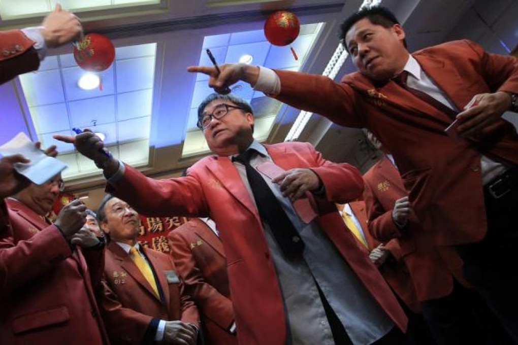 Brokers at the Chinese Gold and Silver Exchange Society get down to business on the first day of trading after the holiday. Society president Haywood Cheung Tak-hay said a weakening US dollar would send gold prices soaring. Photo: Jonathan Wong