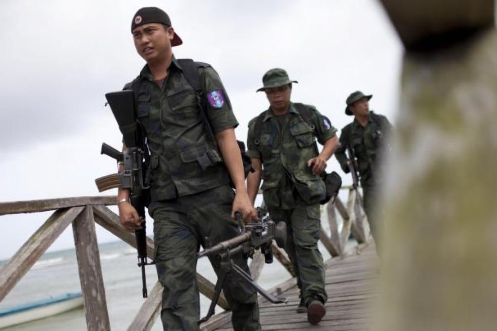 Malaysian armed policemen return from patrol in Tanjung Labian near Lahad Datu, on the Malaysian part of Borneo island. Photo: AFP
