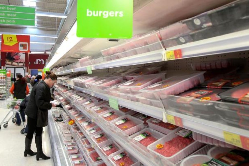 A customer picks up fresh meat at an Asda supermarket in London. Asda has withdrawn its fresh beef bolognese sauce after tests for horse DNA came back positive. Photo: Xinhua