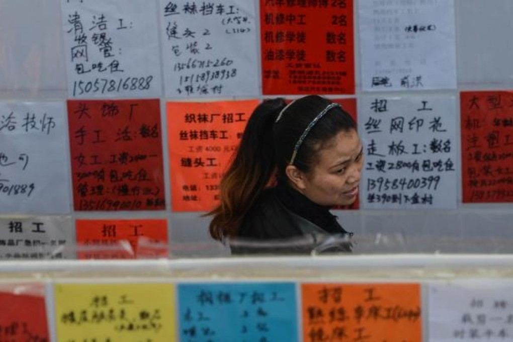 A woman looks at the employment opportunities posted on walls at a job fair in Yiwu, Zhejiang province. Photo: Xinhua