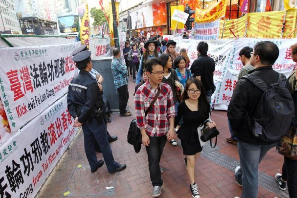 Booths for and against Falun Gong go head-to-head at the junction of Yee Wo Street and Great George Street in Causeway Bay. Photo: Nora Tam