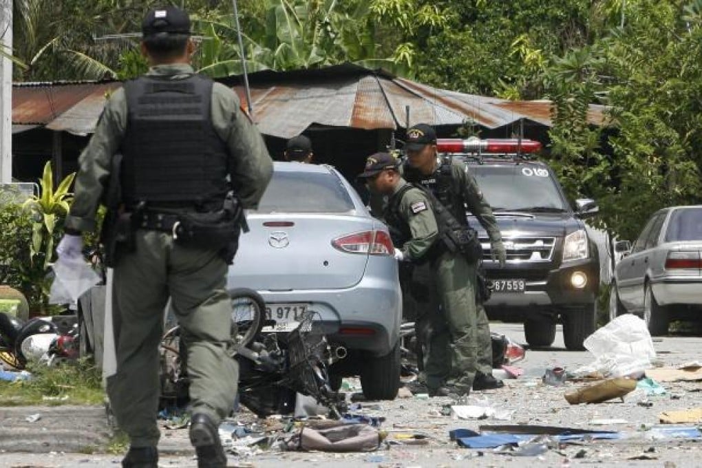 A bomb squad examines the blast site in Pattani. Photo: AFP
