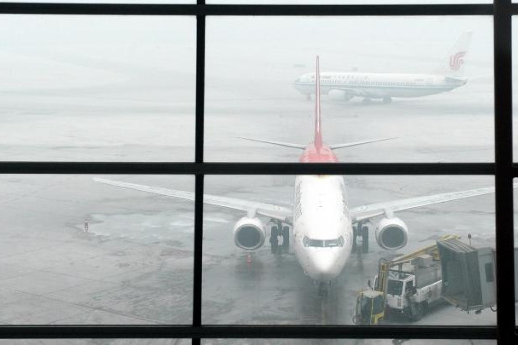 Airliners at Beijing Capital International Airport yesterday morning. Several flights were delayed by the poor visibility. Photo: Xinhua