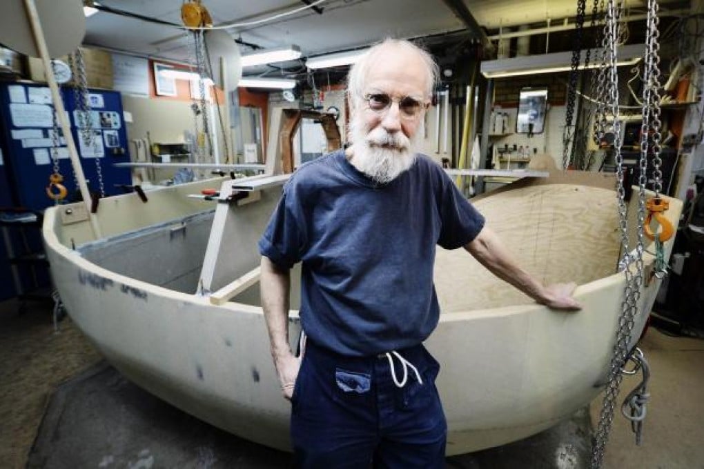 Sven Yrvind in his workshop with his unfinished boat. Photo: AFP